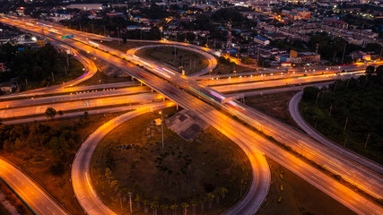 Fototapeta na wymiar circle road traffic in roundabout and highway at night long exposure shot from drone
