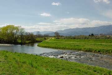 Italian rural landscape. Meschio River with hills in the background. Cordignano, Treviso, Italy.