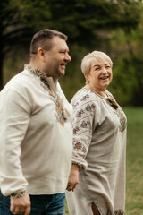 Beautiful senior couple kissing in autumn. Happy old age of a family who has lived a long life together. Copy space. Beautiful senior couple sitting in autumn.