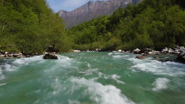 Green river clear fresh water stream in mountains aerial view 4k