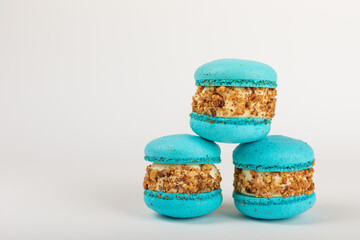 French macaroons on a white background. Macarons with dor blue and pear. French dessert. Sweet table. Copy space. Place for text.