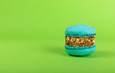 French pasta on a green background. Macarons with dor blue and pear. French dessert. Sweet table....