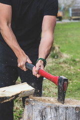 Strong man chopping firewood outdoors - 502970866