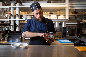 Focused chef mixing ingredients into bowl