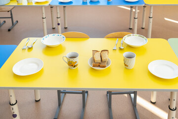 Lunch at a kindergarten in Russia. Table setting before meals close-up.