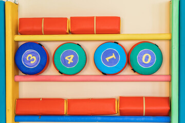 Swedish wall with sports equipment in the kindergarten gym