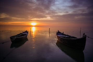 Fototapeta na wymiar fishing boats at sunrise in winter