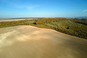Aerial view of plowed agricultural field with cultivated fertile soil prepared for planting crops...