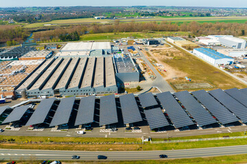 Fototapeta Aerial view of solar panels installed over parking lot with parked cars for effective generation of clean energy obraz