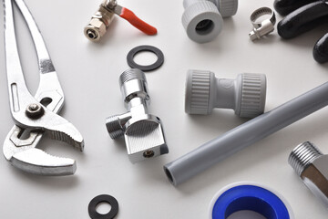 Detail of group of plumbing equipment on white workbench