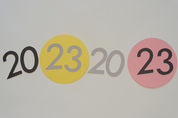 the year 2023 repeated twice (or numbers on paper shapes)