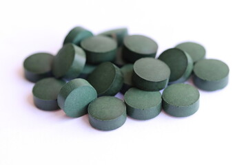 Obraz na płótnie Canvas Spirulina pills isolated on white background, close up.