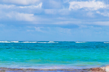 Waves water caribbean coast and beach panorama view Tulum Mexico.