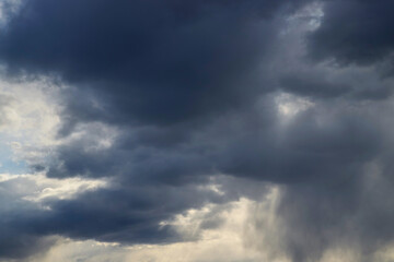 Fototapeta premium Dark thick blue clouds in the evening sky. Dramatic cloudscape. Nature background