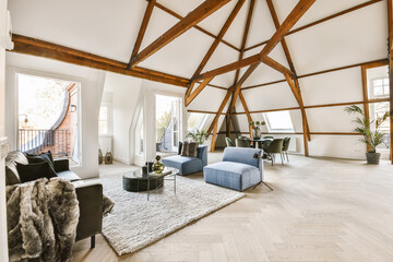 Spacious living room with modern furniture and wood beams on ceiling