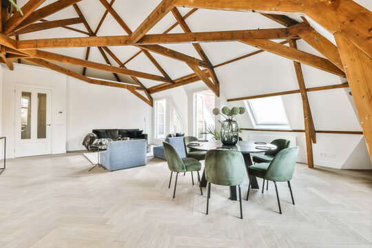 Spacious living room with modern furniture and wood beams on ceiling