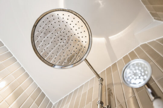 Shower head in cabin in modern bathroom