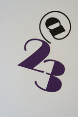 sign with the at @ sign and the number twenty three (or the year 2023)