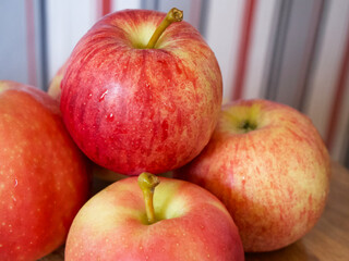 A few ripe striped apples, a close-up shot. Apples of the gala and Ligol varieties.
