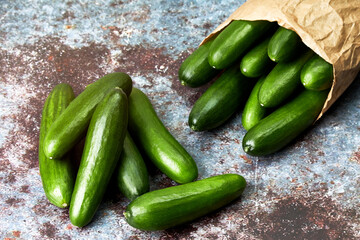 Healthy organic baby cucumbers in a paper bag. Vegan and vegetarian food