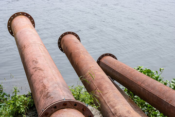 Endpoint of dredging pipelines on the riverbank close up