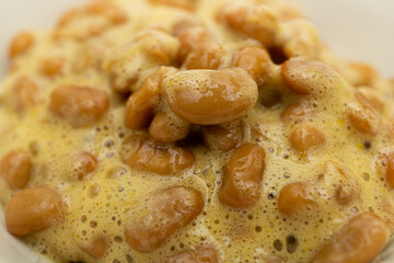 Delicious looking natto in a bowl on a white background