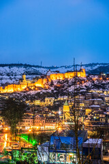 Fototapeta na wymiar Snowing in Tbilisi city in the evening