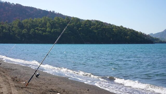 Fishing rod on sea beach in scenic windy landscape. 4k stock video footage of beautiful turkish landscape, Marmaris, Turkey country