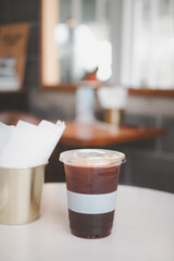 Ice coffee americano in take away plastic cup.