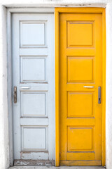 Obraz na płótnie Canvas Rustic white and yellow doors of Greek island