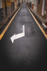 Rainy wet asphalt with sign long road.