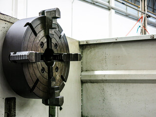 Old, rusted lathe chuck and key 4-jaw screw chuck. A device for fixing parts or tools on the spindle. Spare parts for lathes. Explanation illustration