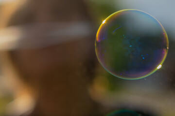 blurry background with soap bubble and silhouette of a person