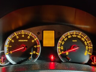 Picture of instrument cluster of a car with lights on shot at night