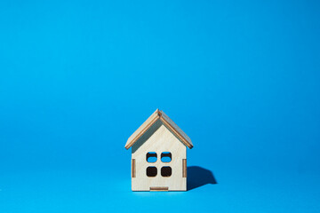 Wooden house on a blue background. Real estate purchase and sale concept. Real estate services	