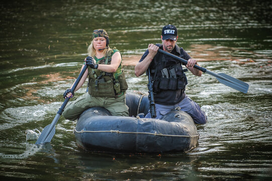 Female Special Forces Training In Rubber Boat Moving Across River