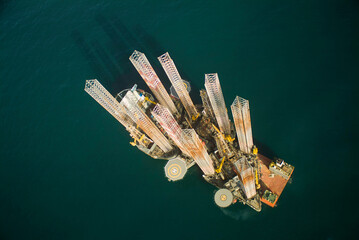 Aerial view of a semi-submersible cargo ship with 3 drilling platforms on board
