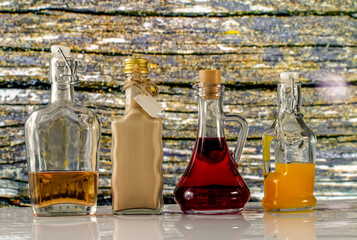 bottles and colorful liquors on a wooden wall