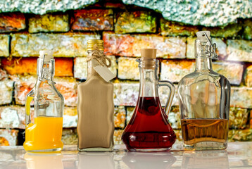 bottles and colorful liquors on the background of the old wall