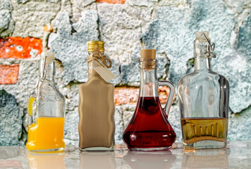 bottles and colorful liquors on the background of the old wall
