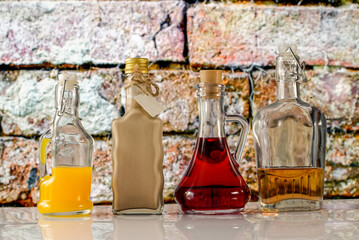 bottles and colorful liquors on the background of the old wall
