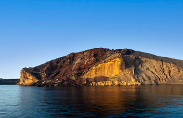 Fototapeta premium The Linosa volcano called Monte Nero in the beach of Cala Pozzolana di Ponente, Sicily