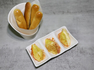 Baked stuffed shells with ricotta, parmesan and mozzarella cheese and garlic butter breadsticks on the side.