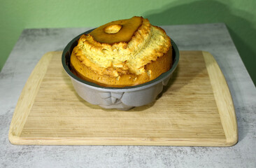 A Poppy seed cake  domed and cracked  due to overfilling the Bundt cake mold with batter.