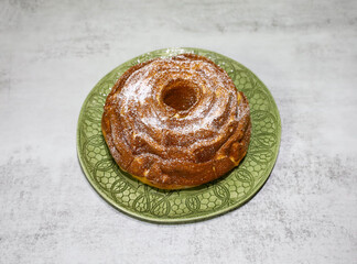 A poppy seed Bundt cake sprinkled with powdered sugar on top.