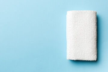 Top view of white towels with copy space on colored background