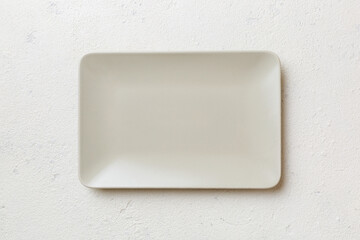 Top view of empty square plate on cement background. Empty space for your design