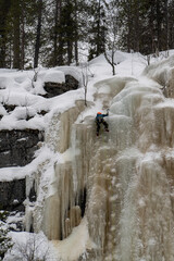 A Cliff Climber on Frozen Waterfalls in Finland