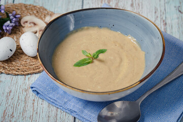 Mushroom soup in blue dish. Top view
