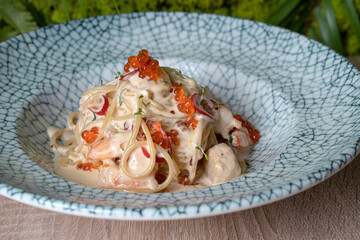 Spaghetti pasta with cream sauce and red caviar